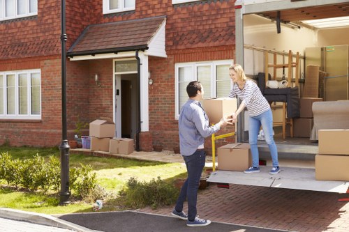 Business relocation scene showing office items being handled carefully by movers