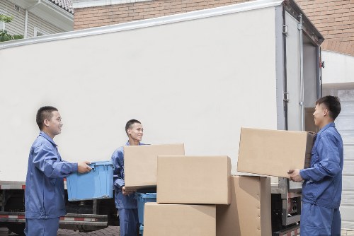 Removals van and moving boxes in a Shepherds Bush street