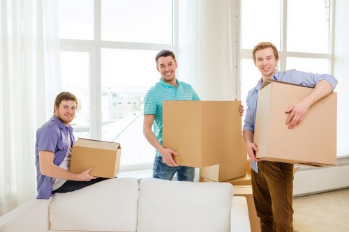 Removal vehicle and movers handling furniture near Shepherds Bush streets
