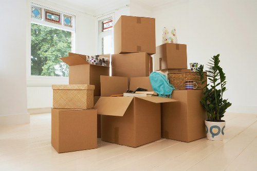 Packed boxes and furniture in a West London flat move
